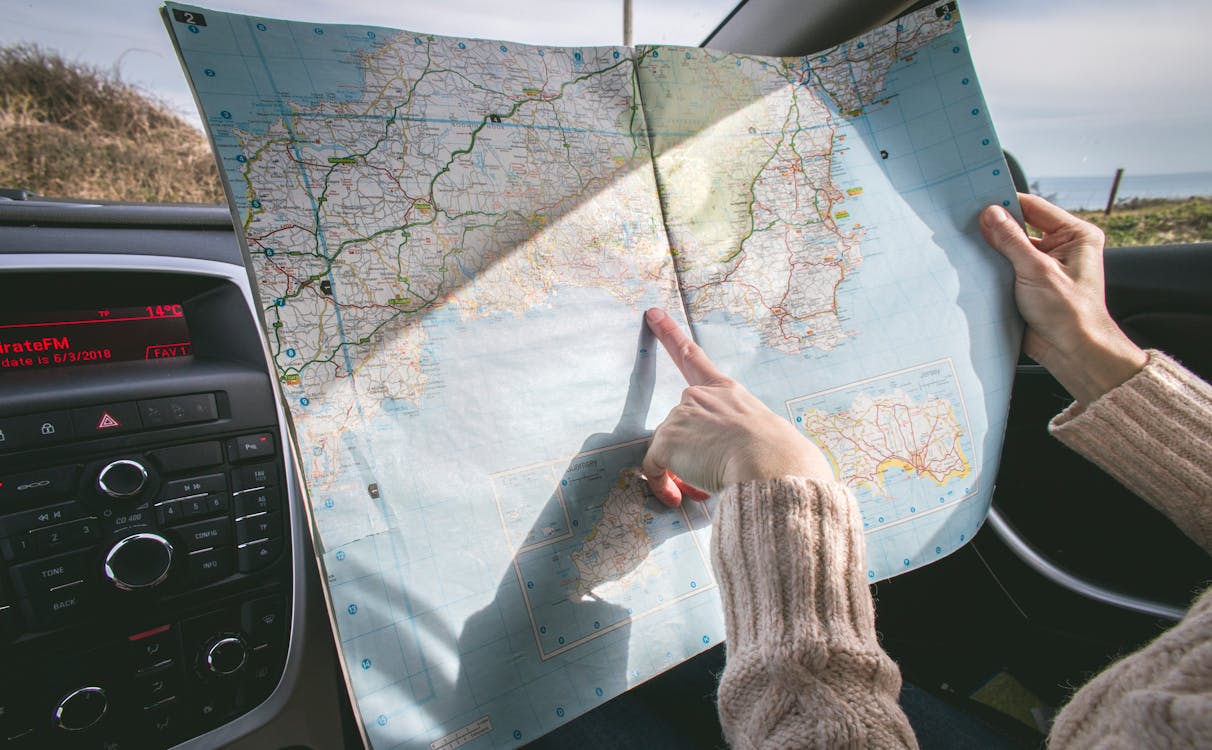 An event planner reviewing weather forecasts and transportation maps.